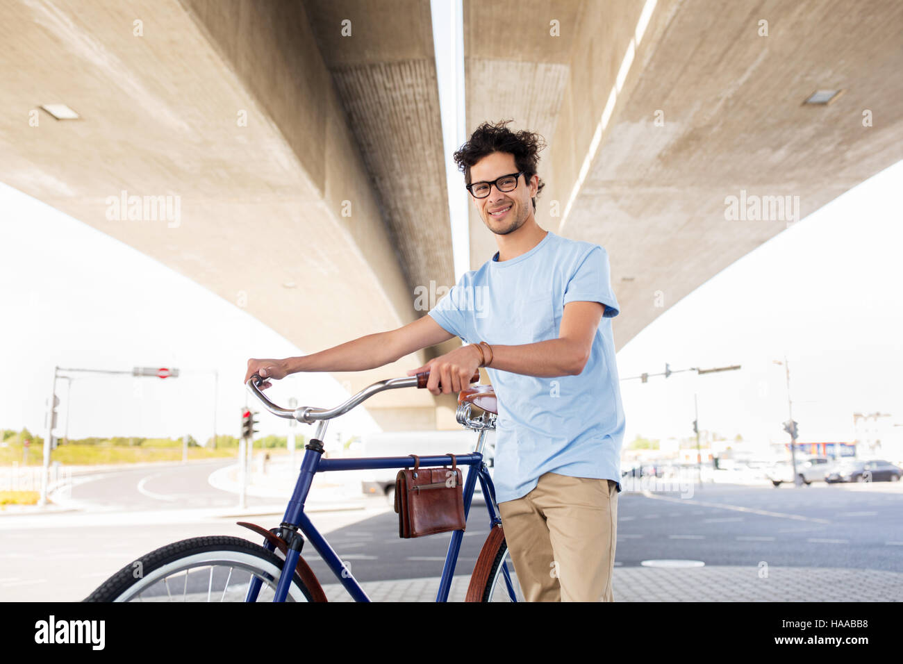 hipster man with fixed gear bike under bridge Stock Photo Alamy