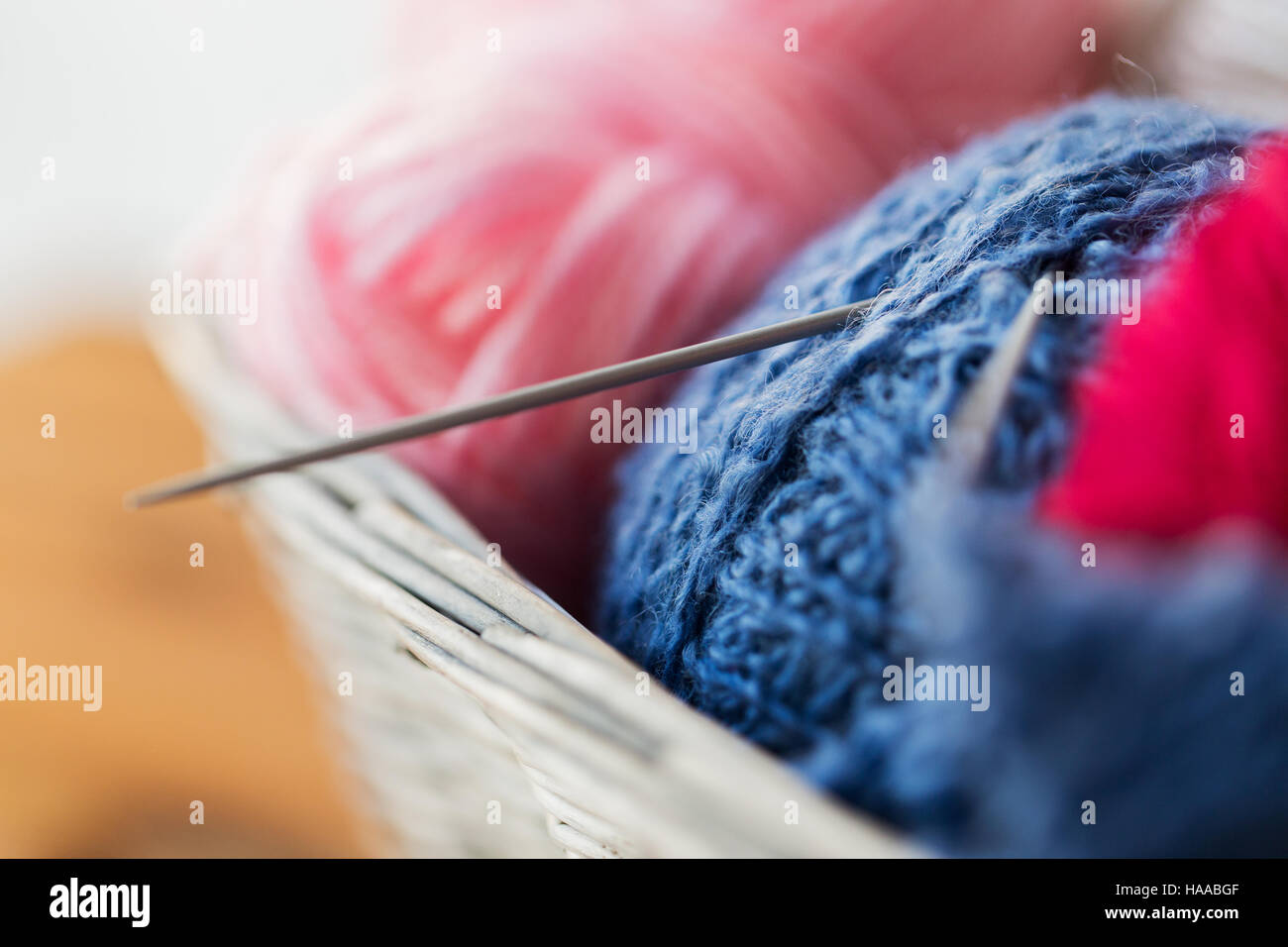 basket with knitting needles and balls of yarn Stock Photo - Alamy