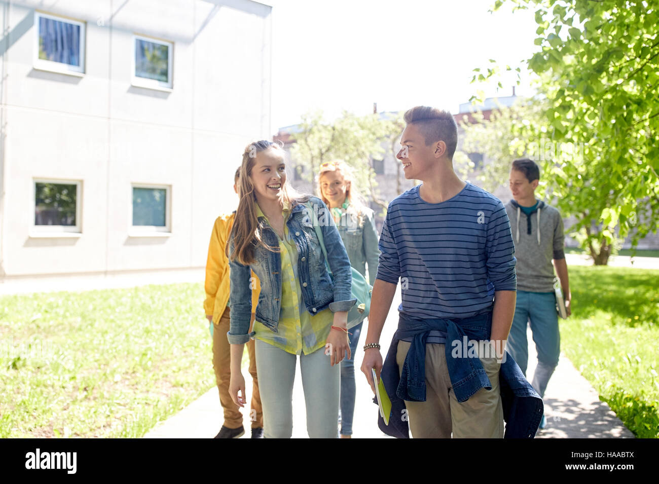 group of happy teenage students walking outdoors Stock Photo - Alamy