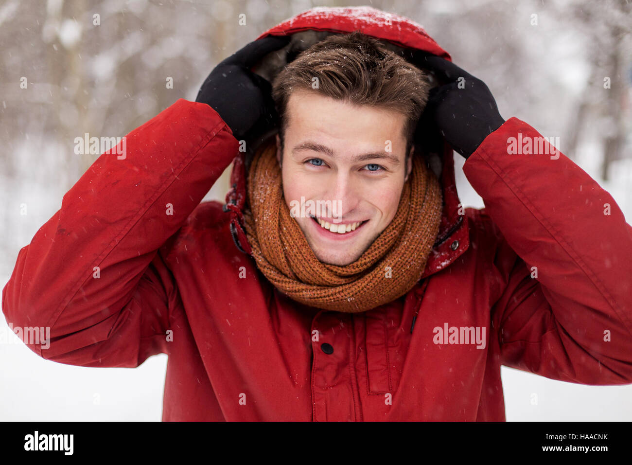 happy man in winter jacket with hood outdoors Stock Photo - Alamy