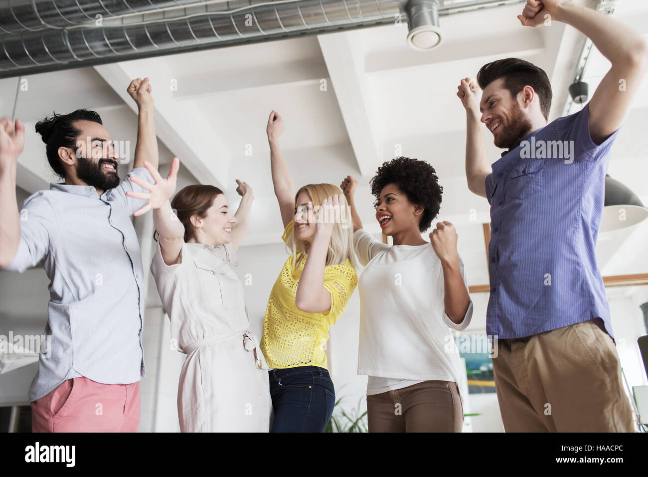 happy creative team celebrating victory in office Stock Photo - Alamy