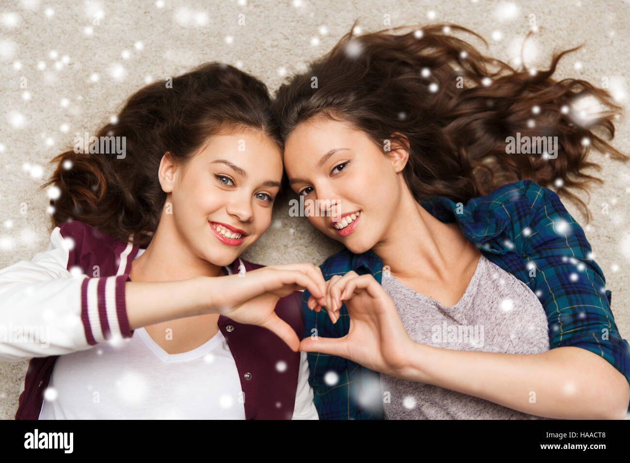 happy teenage girls lying on floor with heart Stock Photo - Alamy
