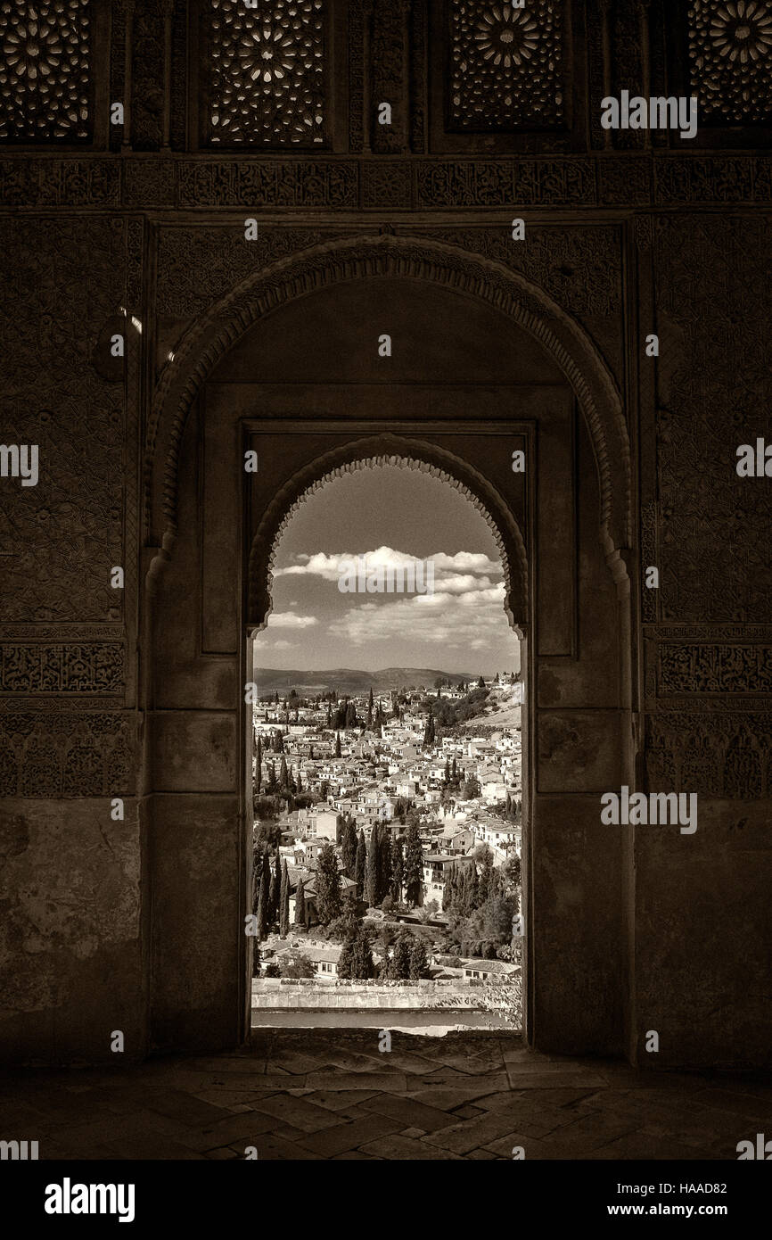 view of Granada through arched window of the alhambra palace Stock Photo