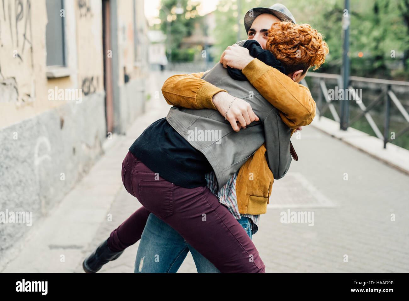 Two friends man and woman meeting in the street of the city, smiling ...