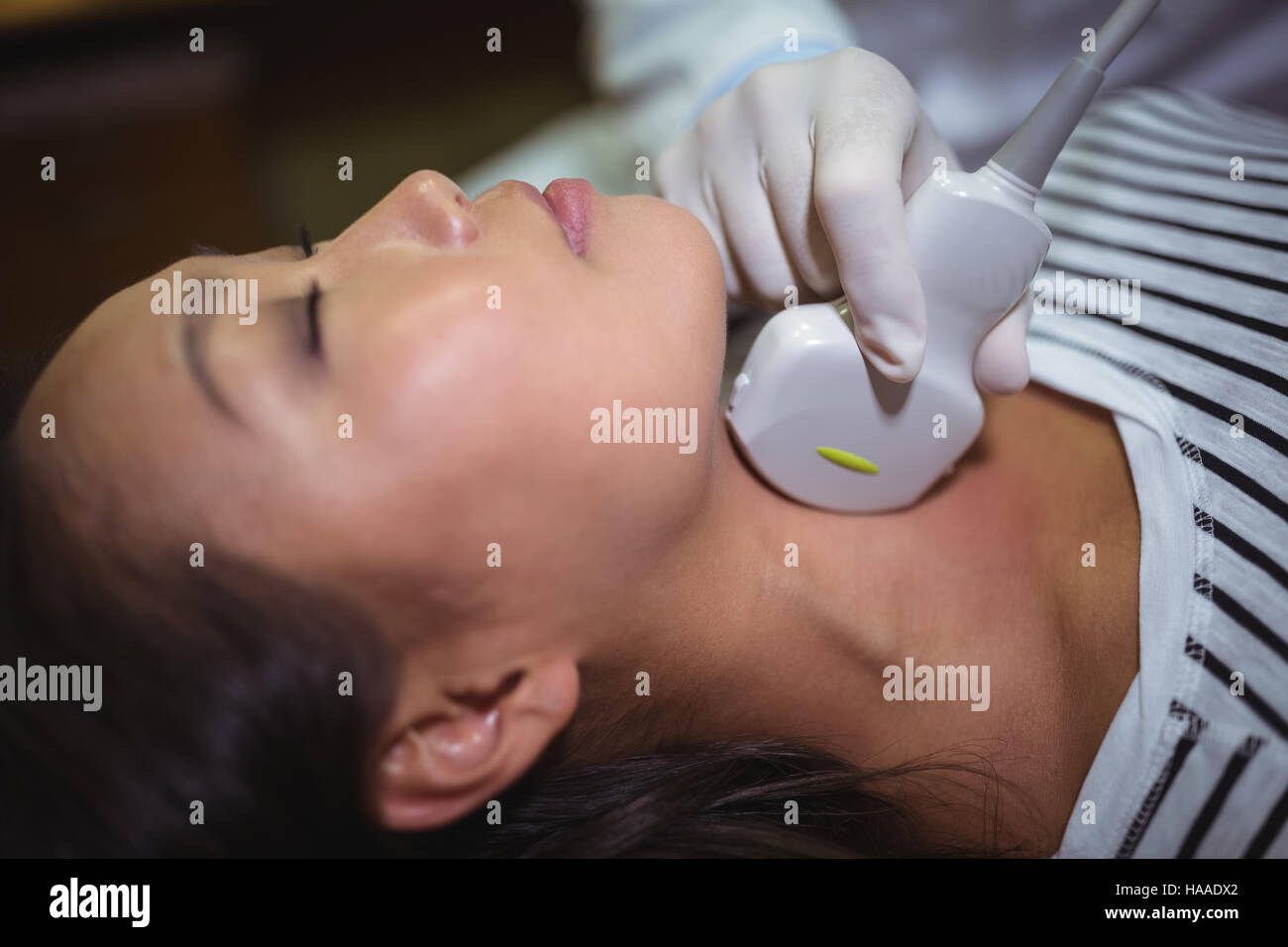 Female patient receiving a ultrasound scan on the neck Stock Photo