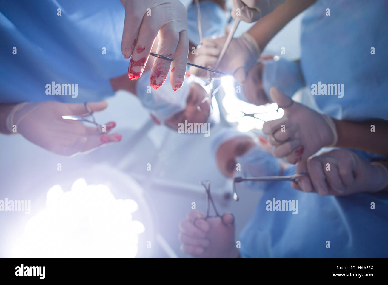 Group of surgeons performing operation in operation room Stock Photo ...