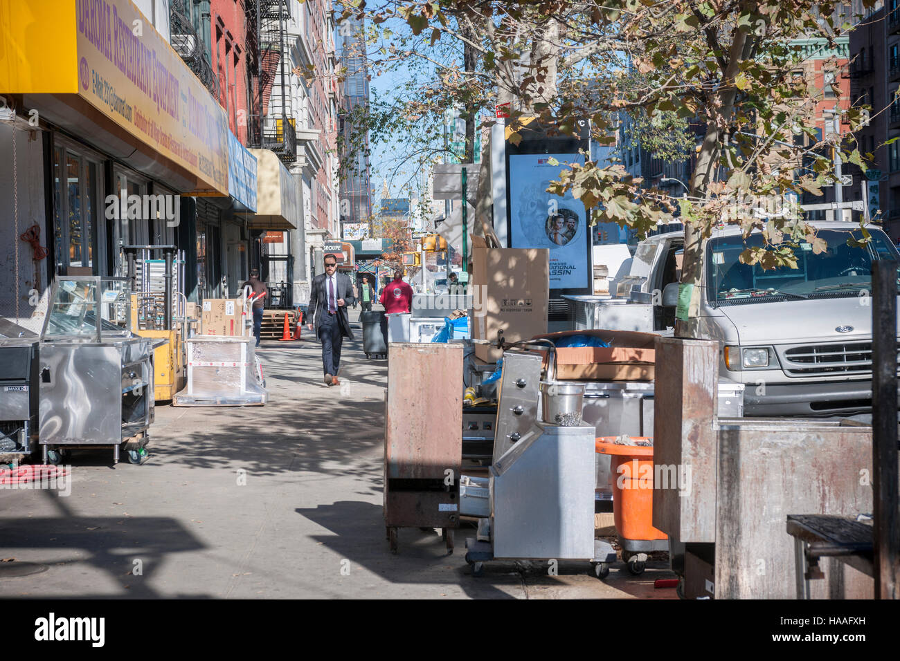 Passerby maneuver through restaurant equipment from a restaurant