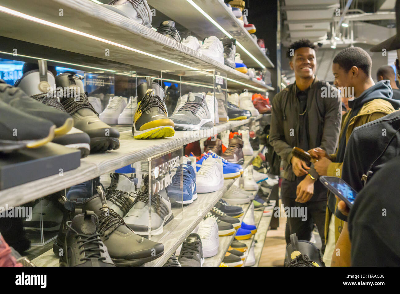 Customers crowd the new Nike flagship store on opening day in Soho in New York on Friday