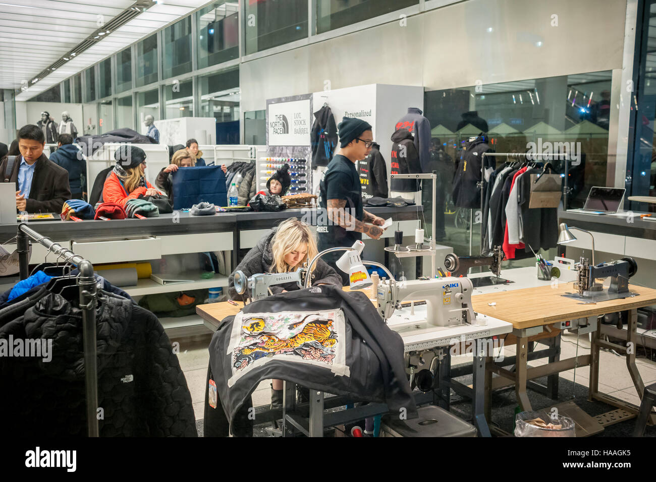 Customers wait to have their purchases customized at the North Face store on Fifth Avenue in New York on Tuesday, November 22, 2016. (© Richard B. Levine) Stock Photo