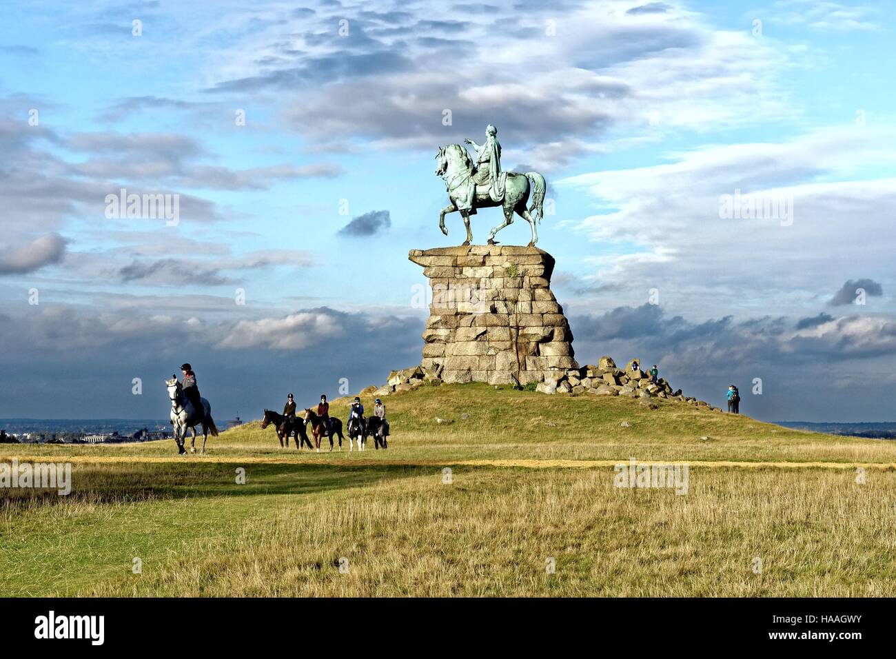 George third statue in Windsor great park with horse riders in foreground Berkshire UK Stock Photo