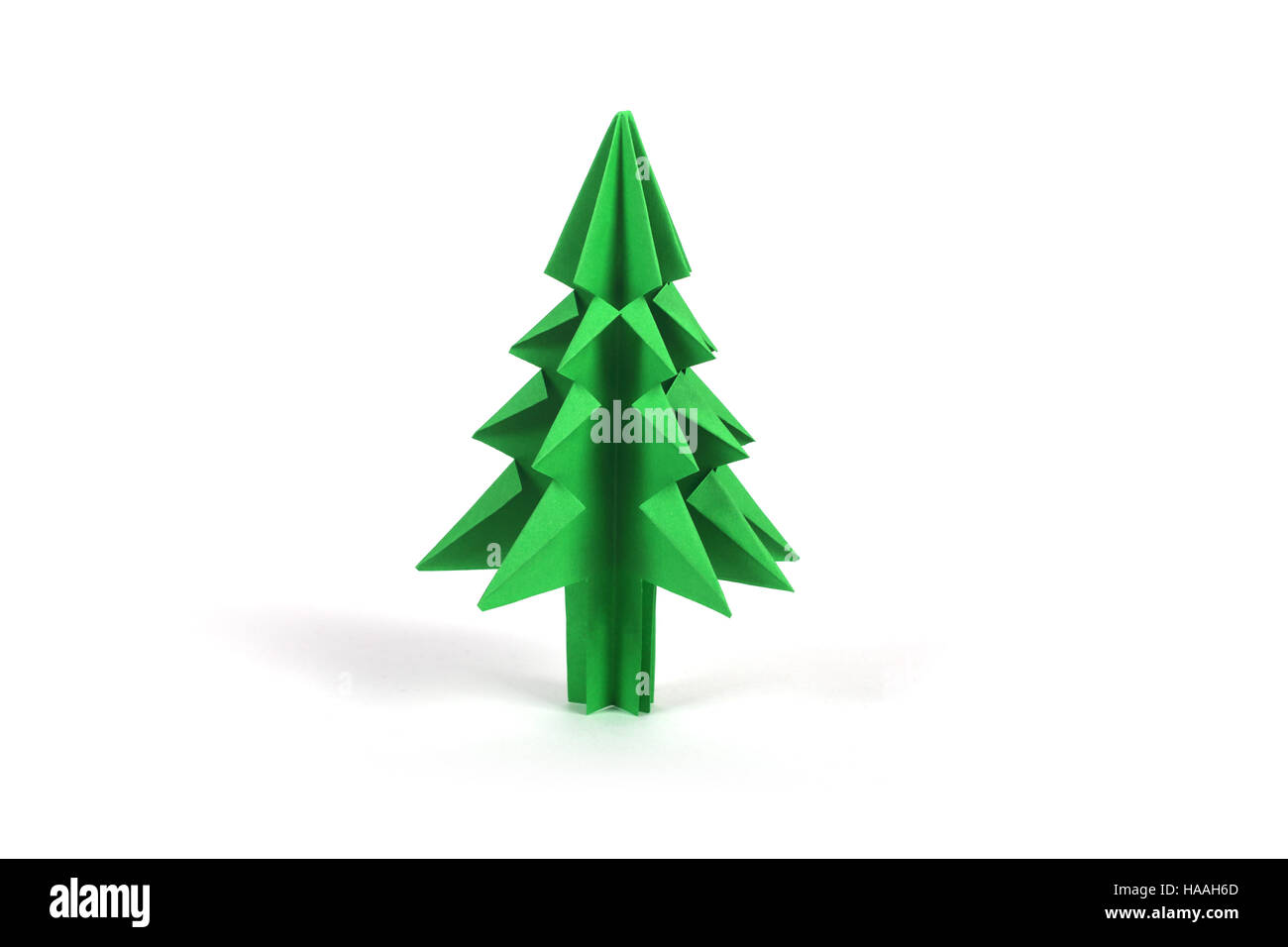 Green origami christmas tree isolated on white background Stock Photo ...