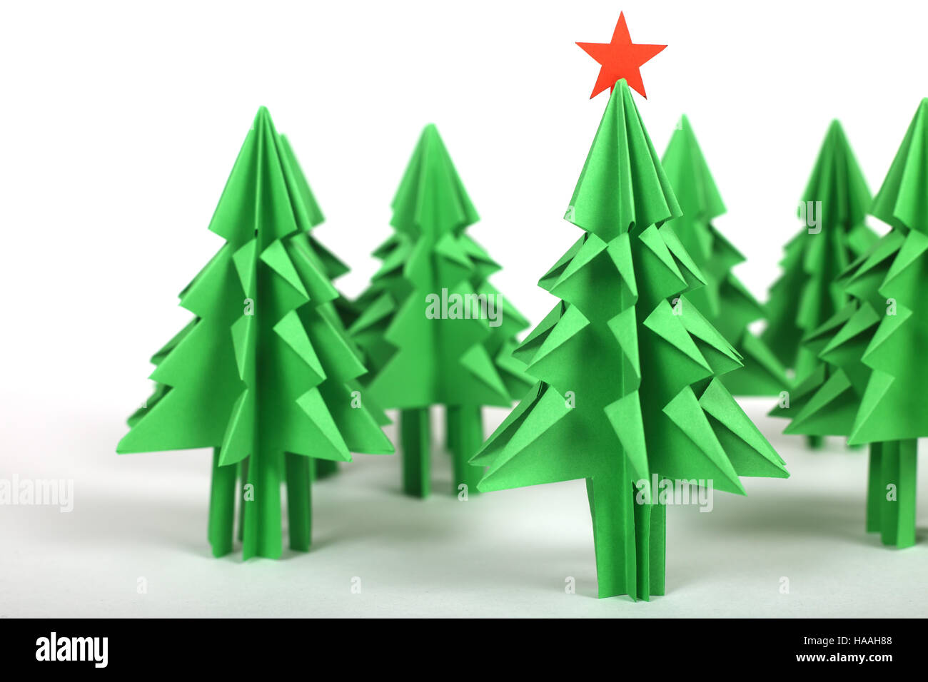 Green origami christmas trees isolated on white background Stock Photo ...