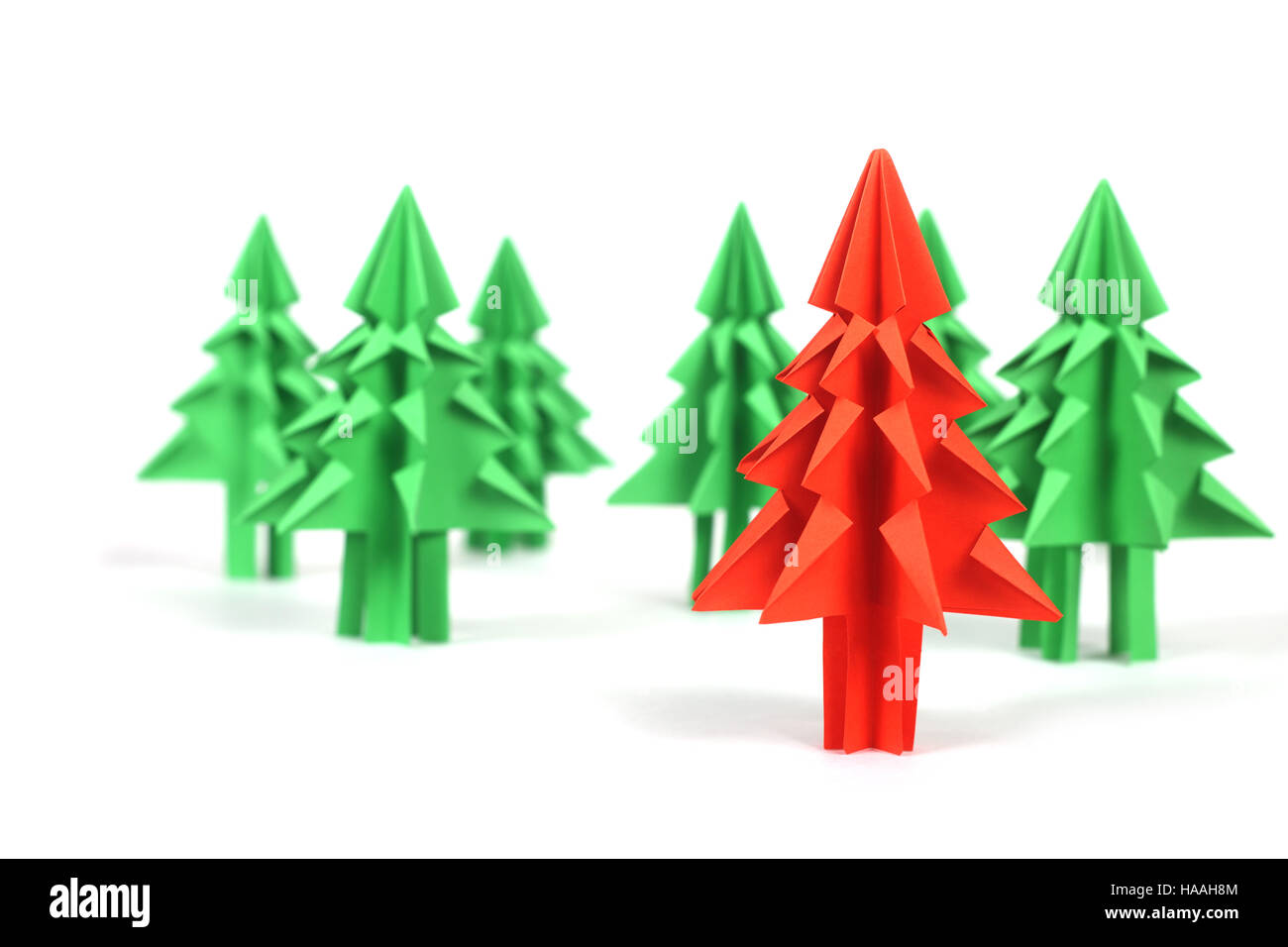 Green and red origami christmas trees isolated on white background ...