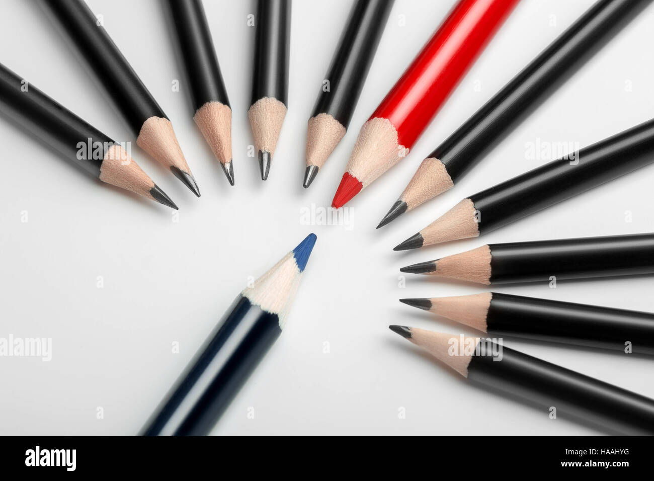 one blue pencil against all black with red leader. Abstract gay discrimination. Stock Photo