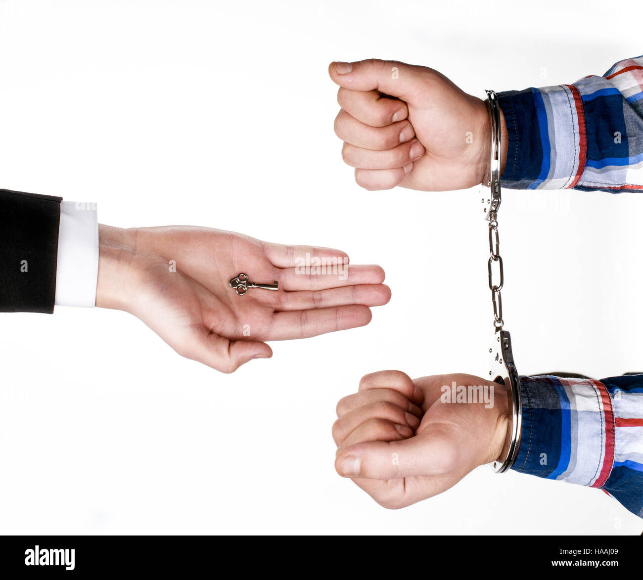lawyer gives key of the handcuffs to prisoner Stock Photo