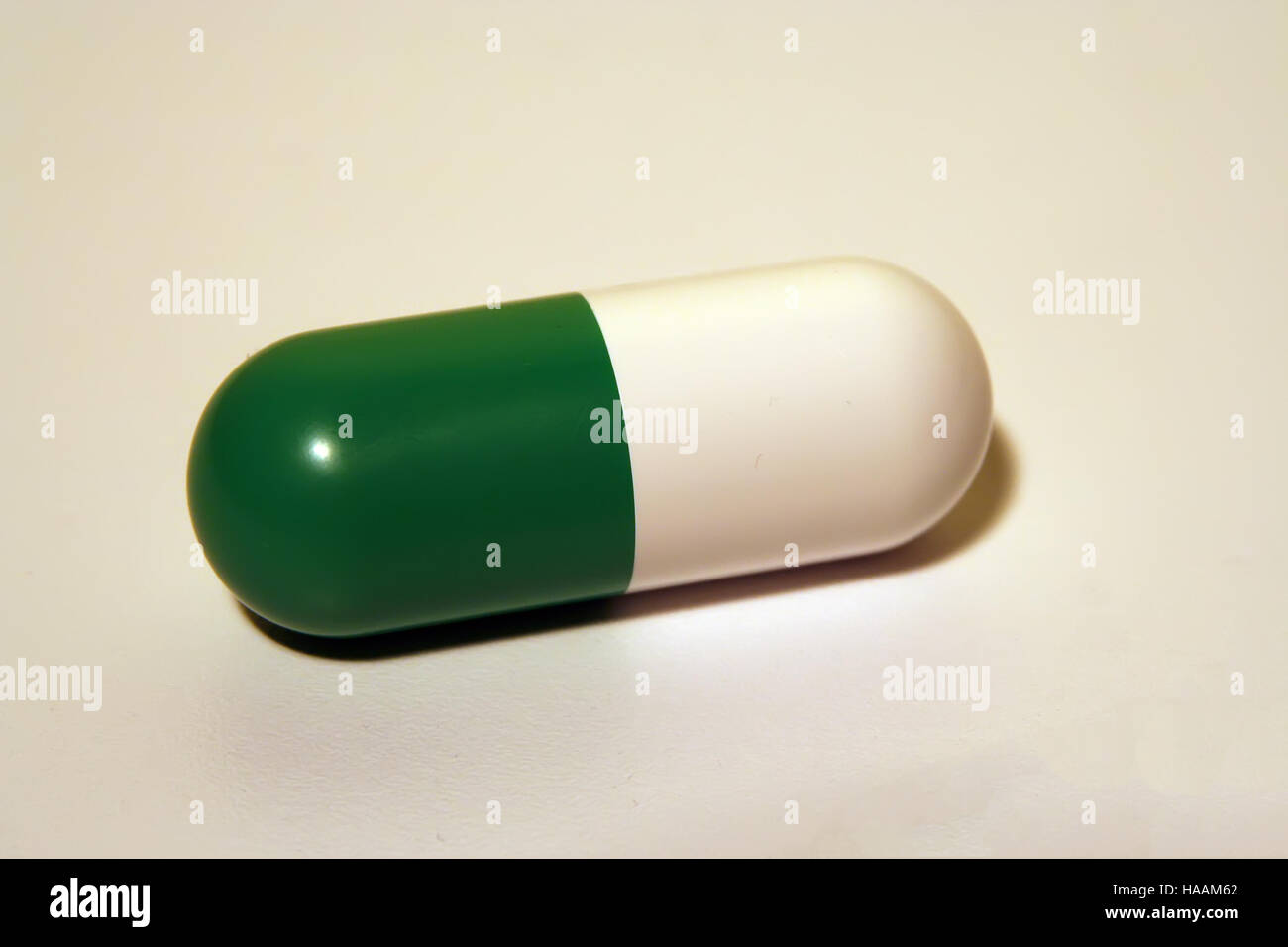 Green and white medical pill. Antibiotic capsule Stock Photo Alamy