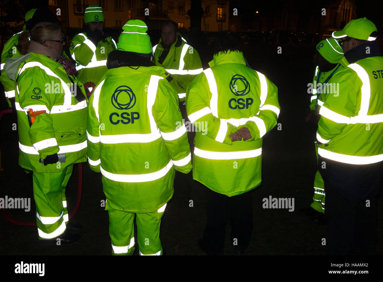 Event stewards in yellow jacket / green hi vis / high visibility jackets with highly reflective stripes / material strips. UK Stock Photo