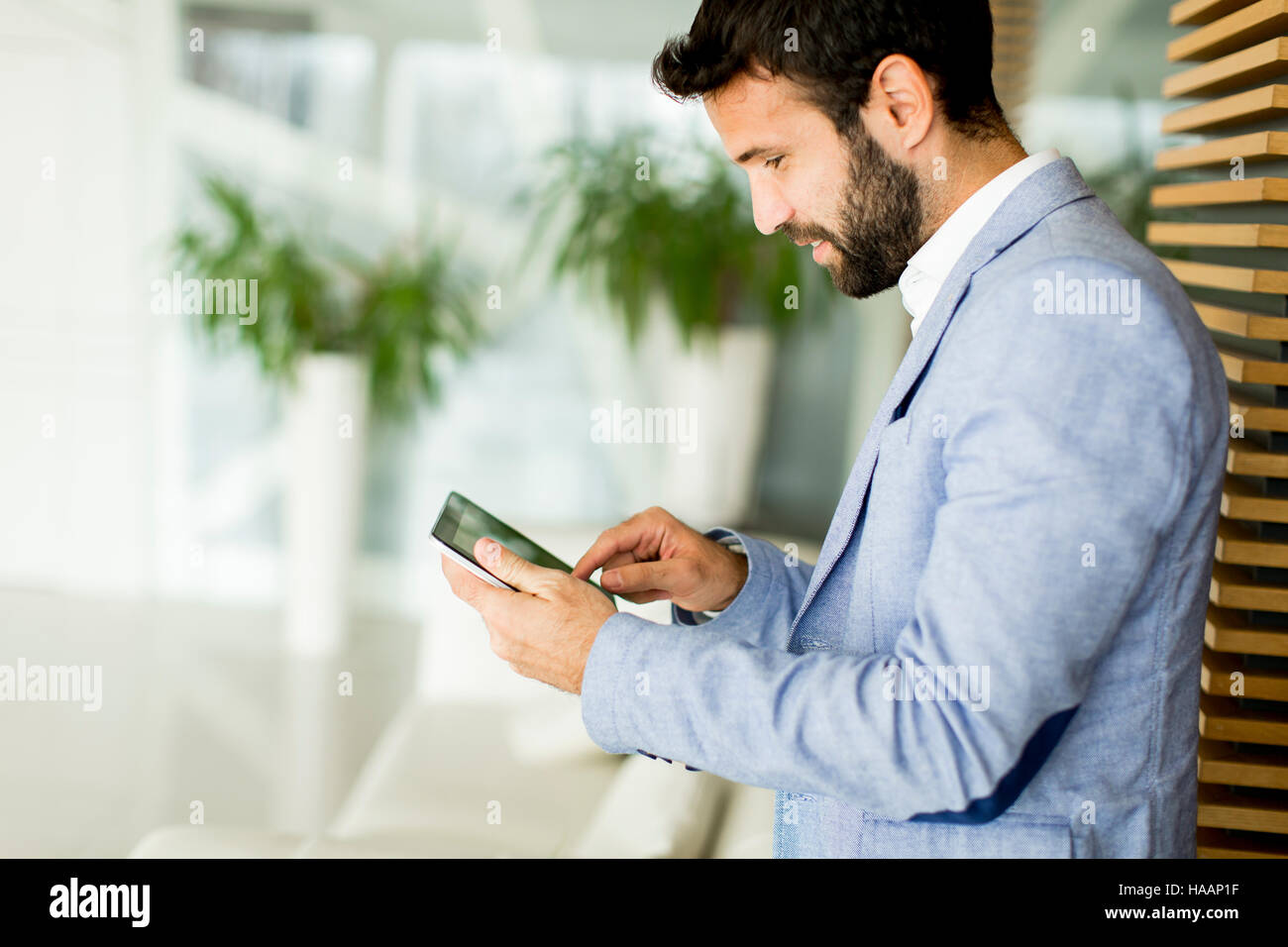 Businessman using his digital tablet at the office Stock Photo - Alamy
