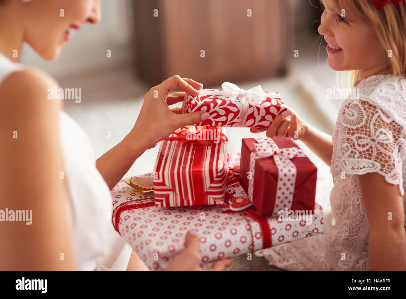 Exchange presents between woman and little girl Stock Photo Alamy