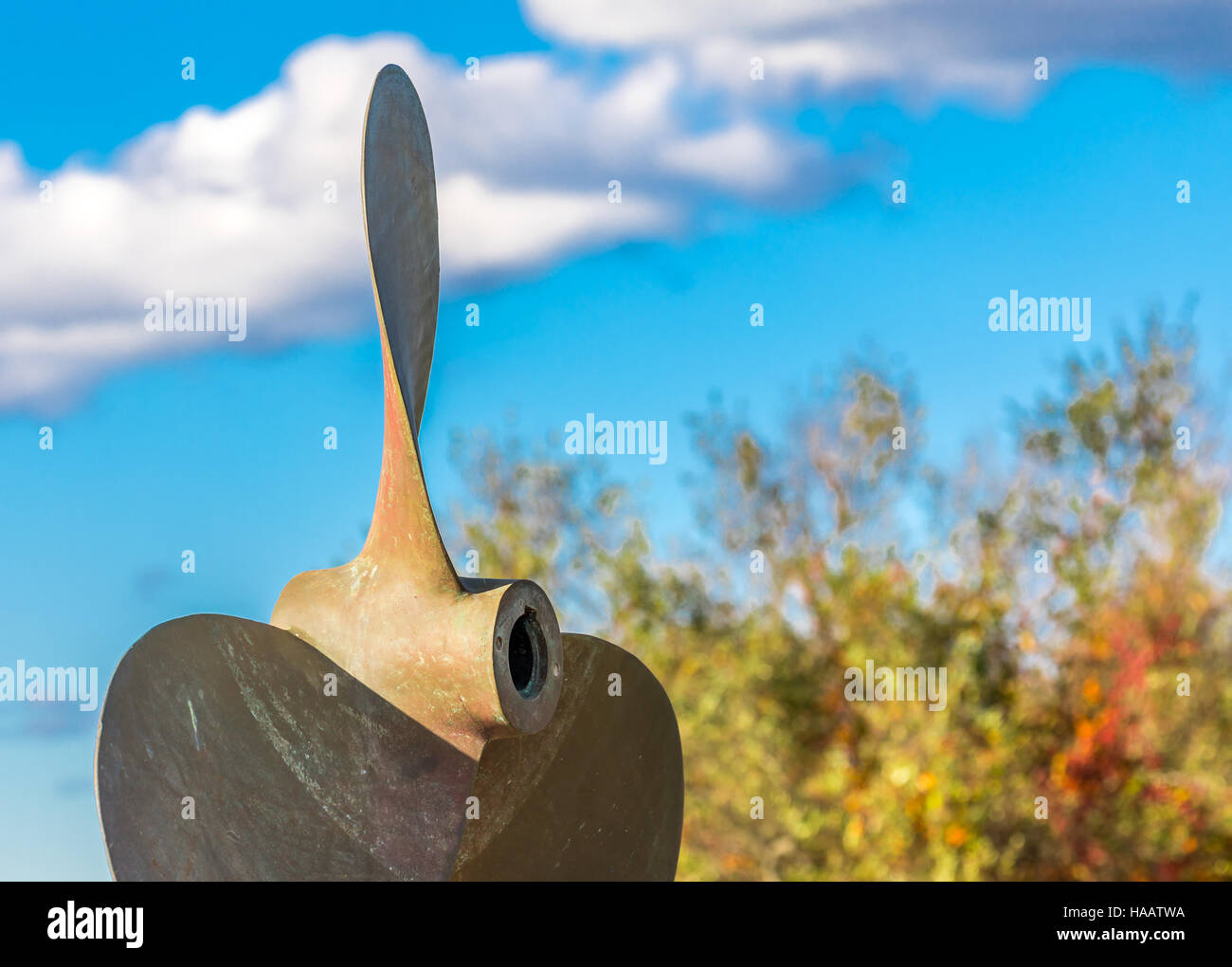 huge boat propeller with sky and trees in the background Stock Photo