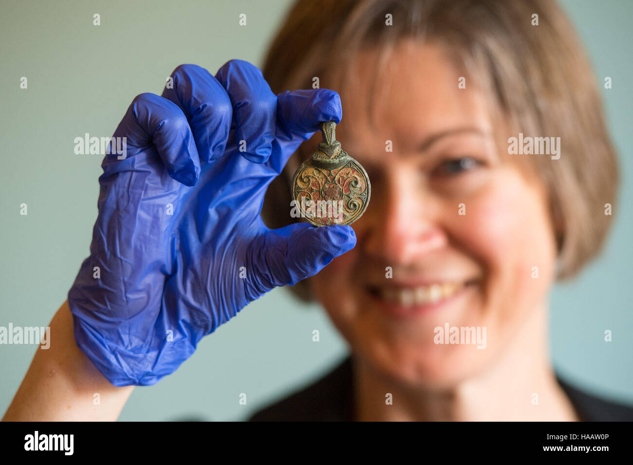 Helen Geake holds an Anglo-Saxon hanging bowl mount from AD 600-725, found in West Sussex, seen during a photocall at the British museum in London for some of the important finds made by the public in 2015 and recorded under the British Museum's Portable Antiquities Scheme (PAS) and Treasure annual reports. Stock Photo