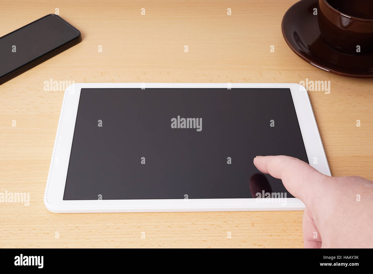 finger touching blank touchscreen on tablet computer Stock Photo