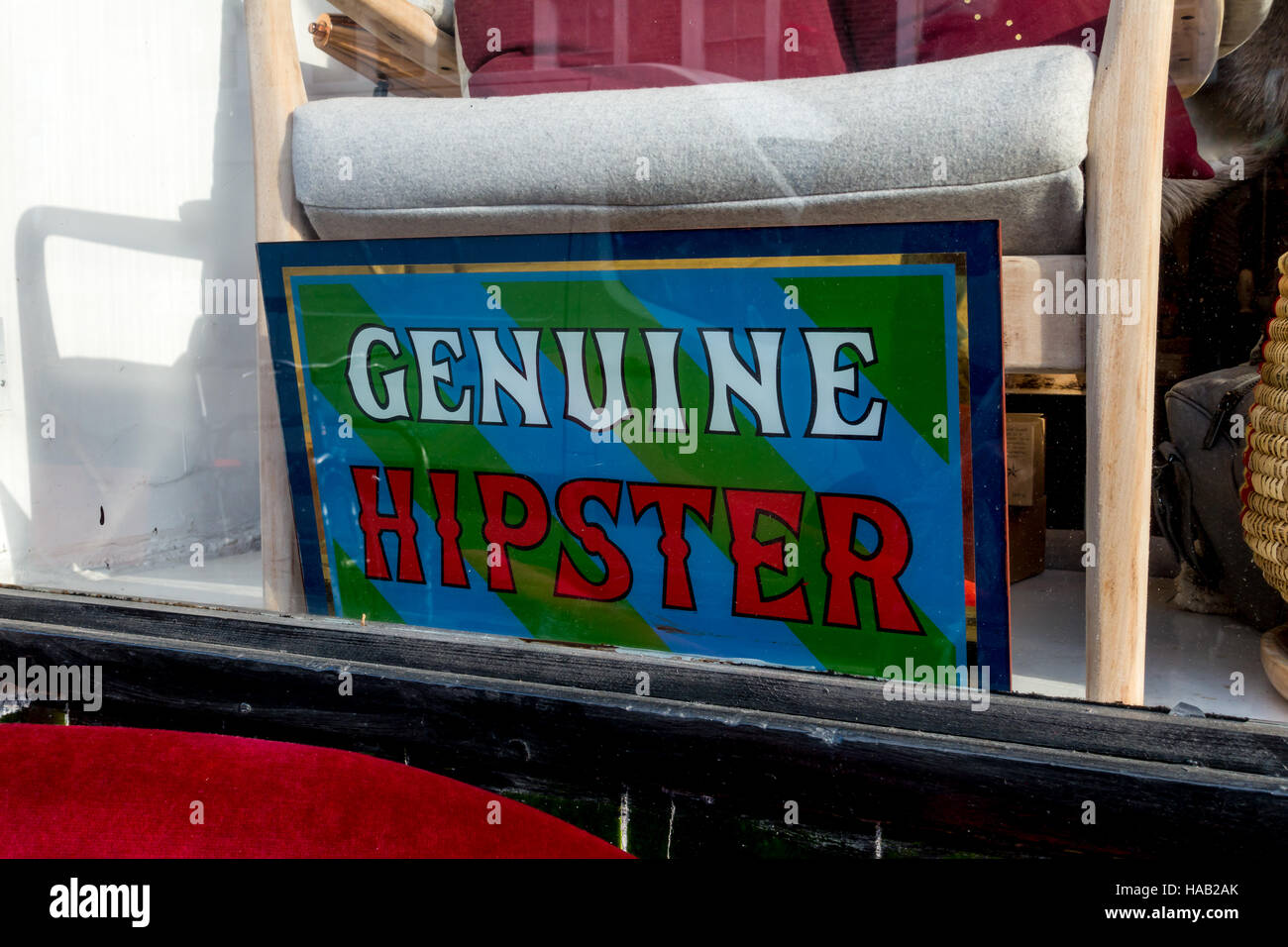 Sign in East London shop window with word Genuine Hipster Stock Photo