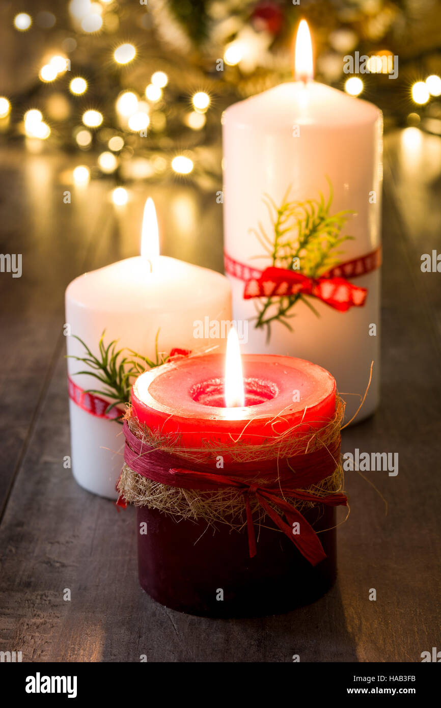 Red Christmas candle and Christmas light on wood Stock Photo
