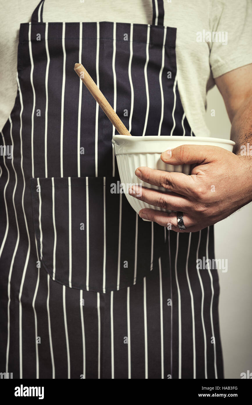 Baker ready with mixing bowl and wooden spoon Stock Photo