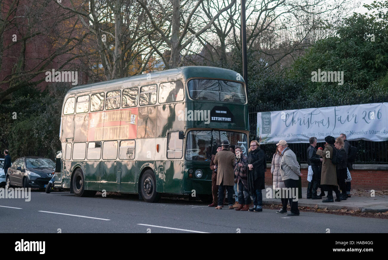 The green battle bus arrives with Dame Vivienne Westwood as her son Joe Corre burns his £5 million pound collection of punk memorabilia in protest to declare 'punk is dead'. The burning took place on a barge on Chelsea Embankment. Stock Photo
