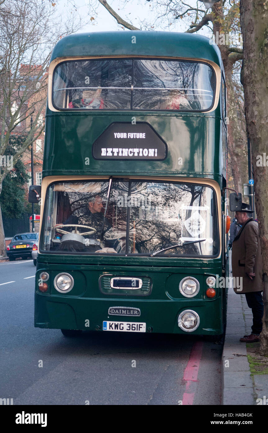 The green battle bus arrives with Dame Vivienne Westwood as her son Joe Corre burns his £5 million pound collection of punk memorabilia in protest to declare 'punk is dead'. The burning took place on a barge on Chelsea Embankment. Stock Photo
