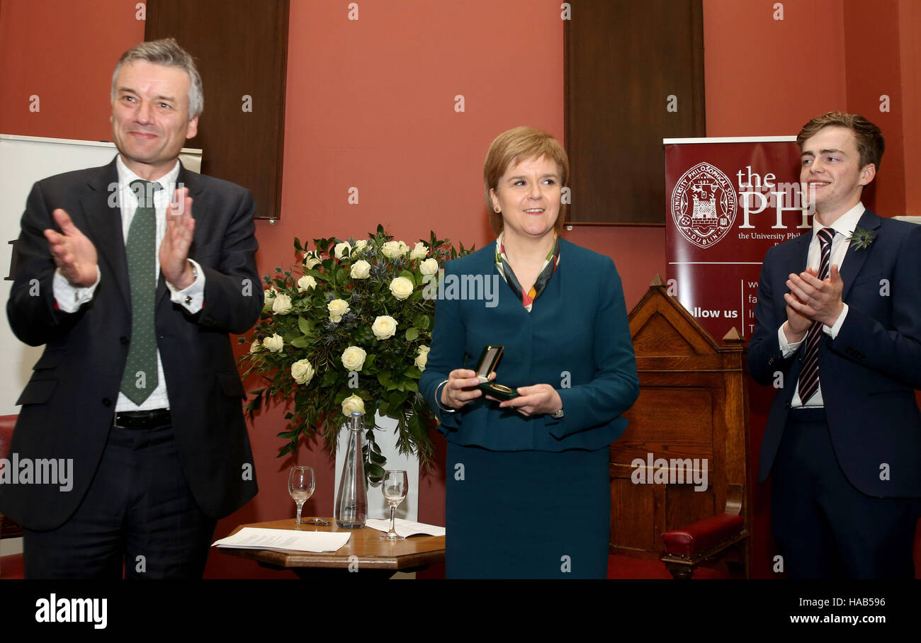 RETRANSMITTING UPDATING CAPTION INFORMATION. Provost of Trinity College Dublin, Patrick Prendergast (left) and Matthew Nuding (right), Chairman of the Trinity College Philosophical Society present Scottish First Minister Nicola Sturgeon with an honorary patronage from the Philosophical Society at Trinity College Dublin. Stock Photo