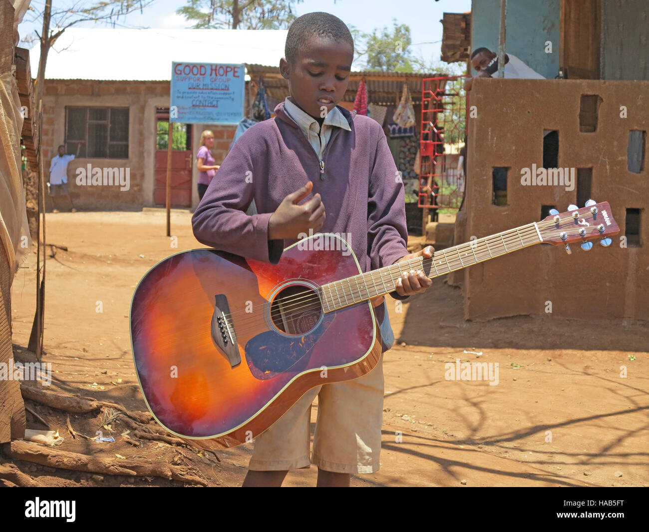 Young African Boy with guitar in Moshi Tanzania playing and learning in  orphanage and day school Stock Photo - Alamy