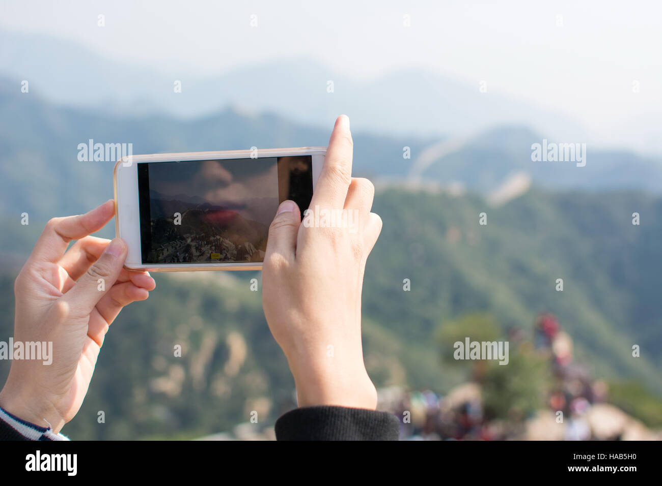 Happy tourist taking picture on the Great Wall of China Stock Photo