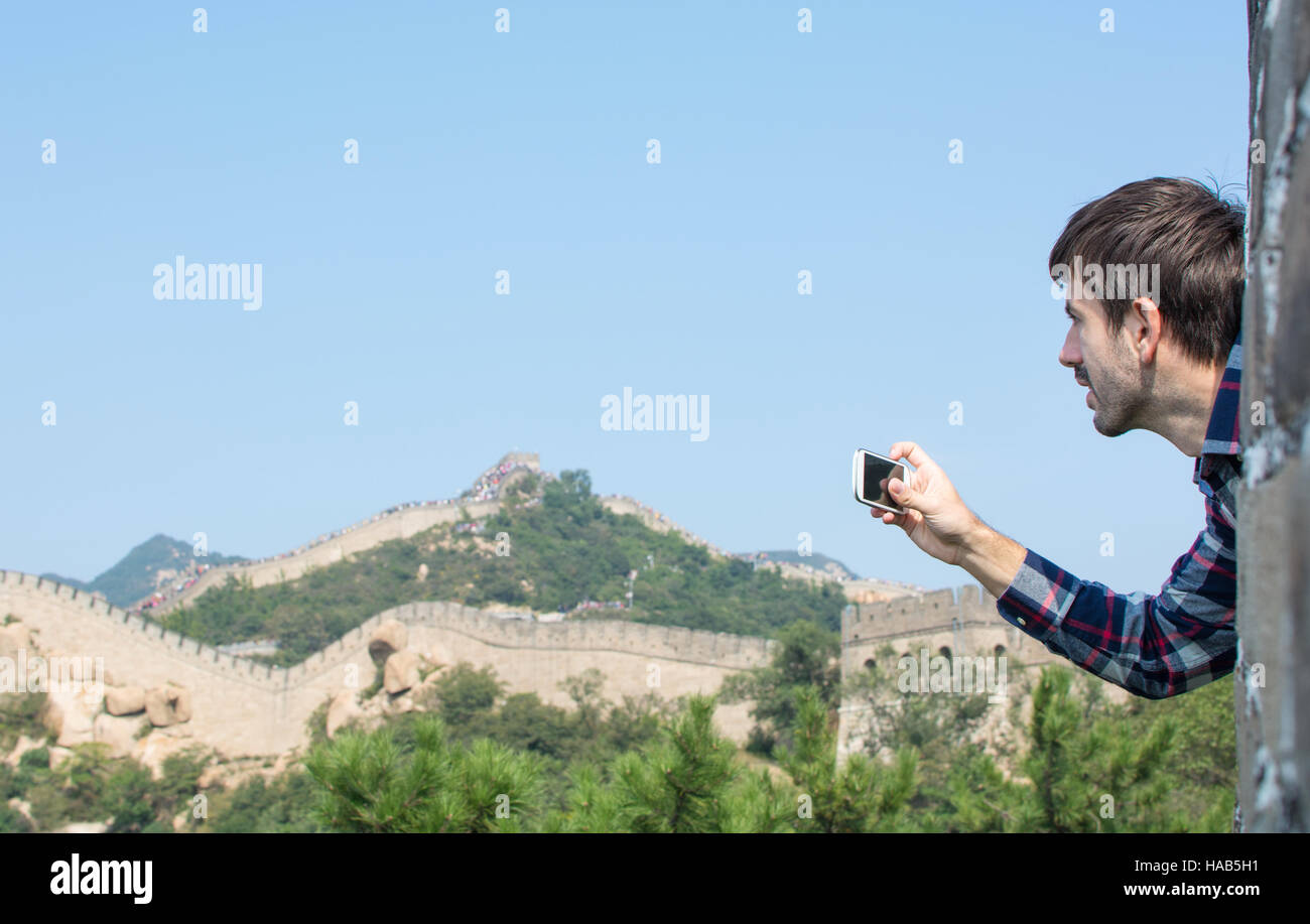 Happy male tourist on the Great Wall of China Stock Photo