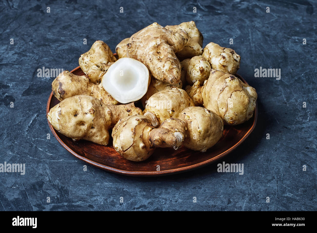 harvest Jerusalem artichokes on a dark slate background Stock Photo Alamy