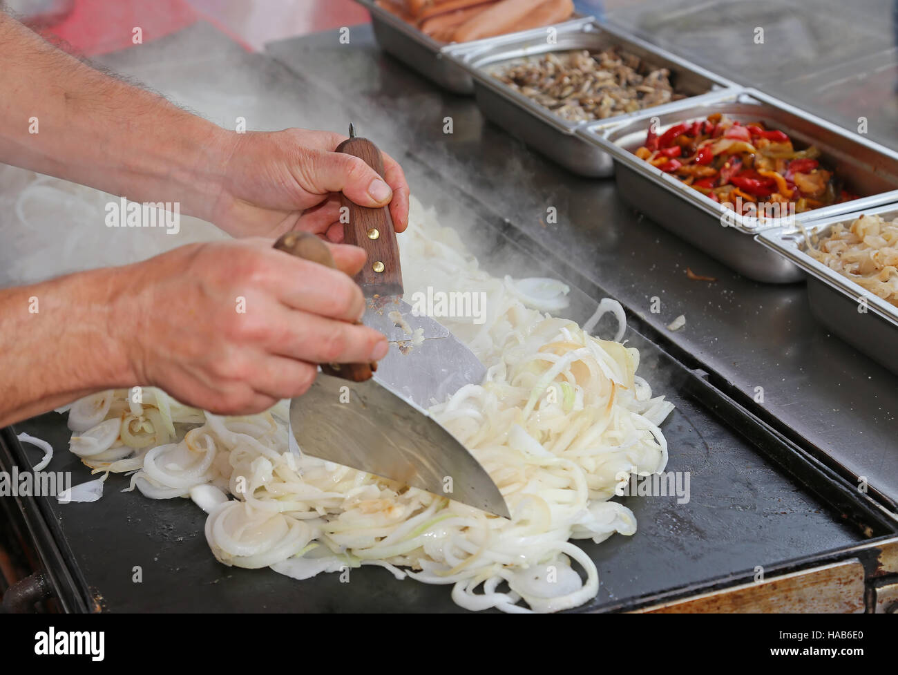 expert chef cooking onions during the preparation of lunch at an