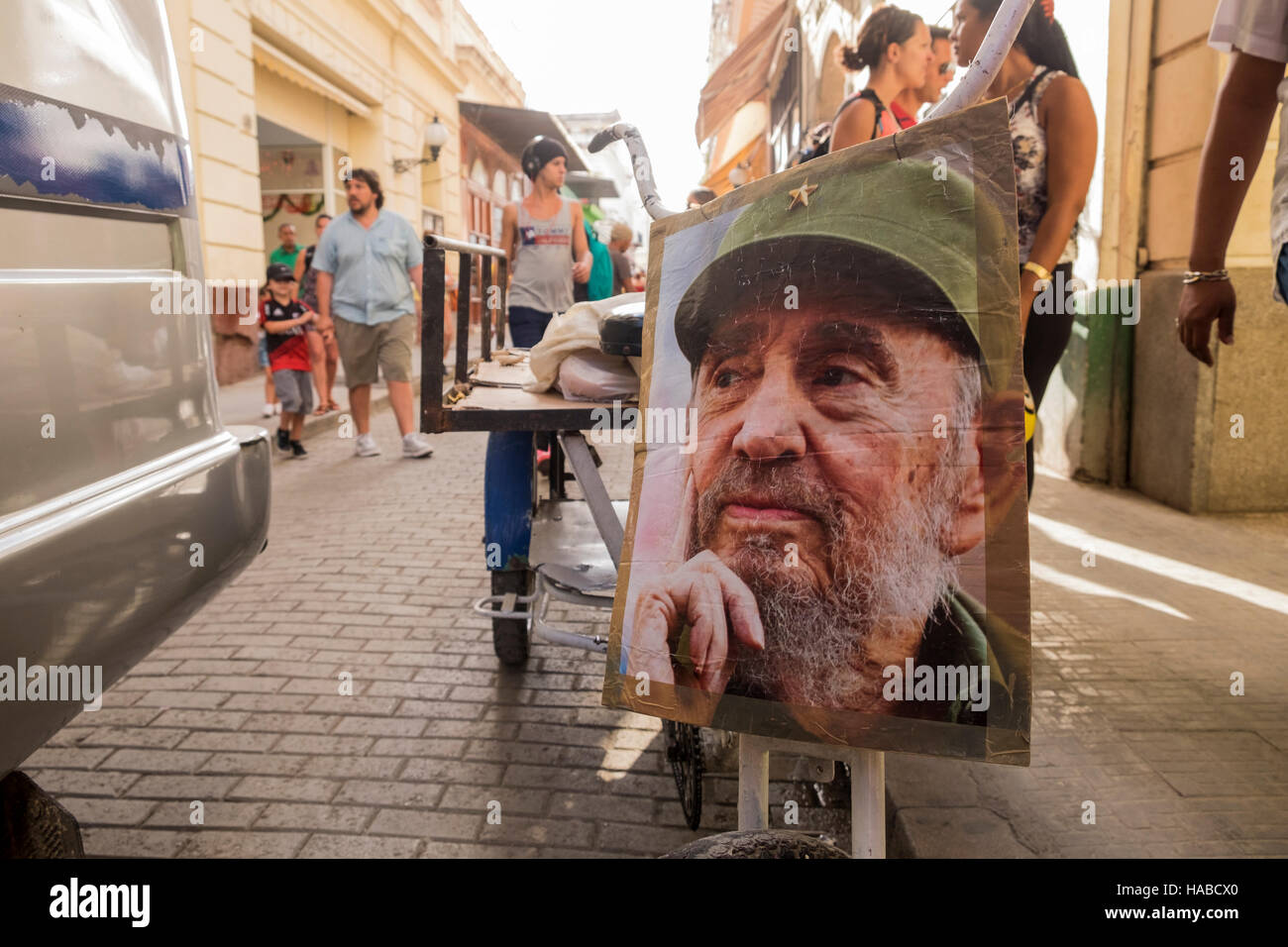 La Havana, Cuba, 26 November 2016. Scenes around the old town of La Havana on the day Castros death was announced. Photo of Fidel Castro attached to front of a delivery mans tricycle on Calle Obispo. Stock Photo