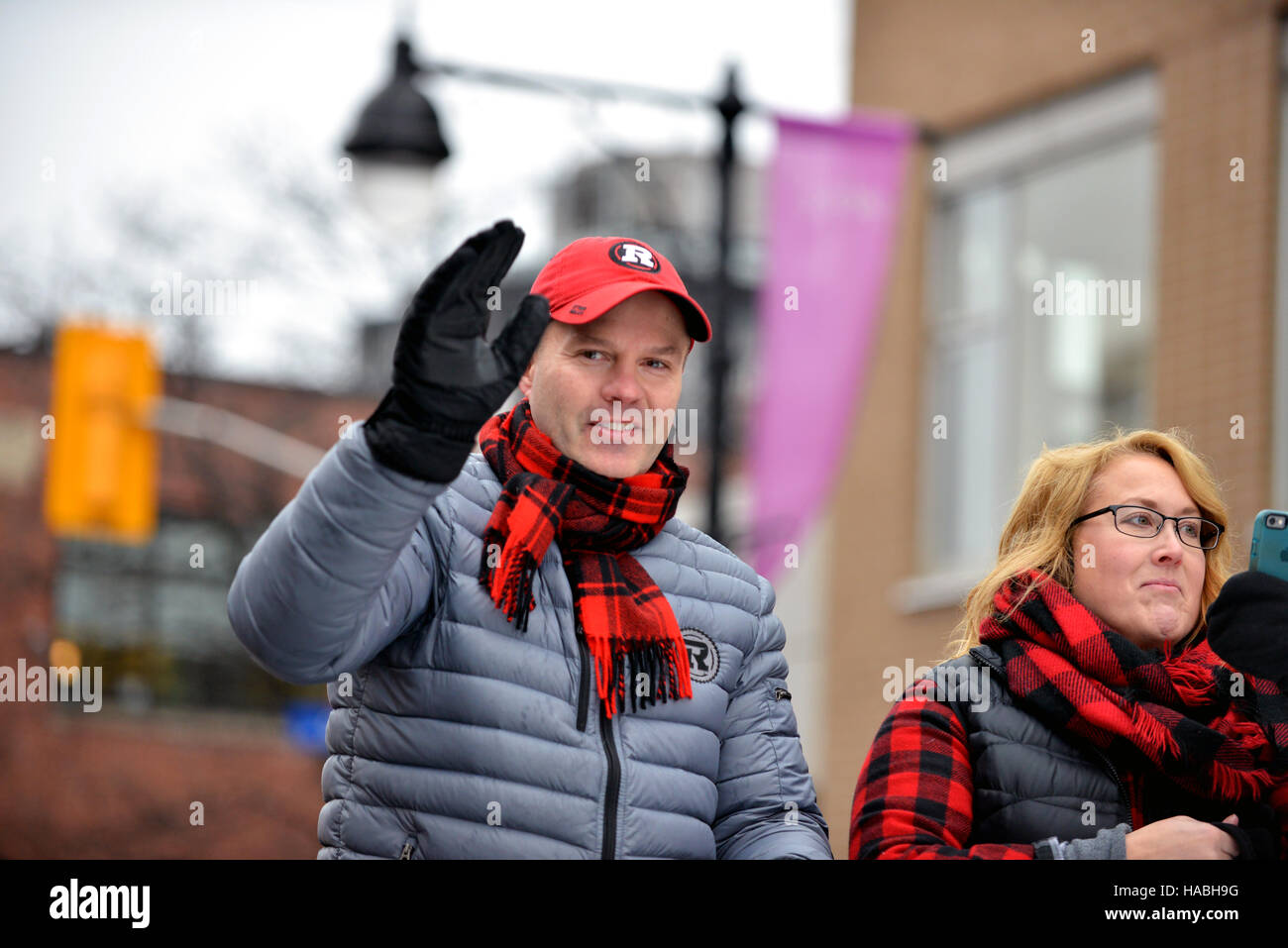 Ottawa, Canada. 29th Nov, 2016. Coach Rick Campbell with wife Jeri during the Grey Cup Parade on Bank Street.  The  Ottawa Redblacks, in only their 3rd season won city's first CFL championship in 40 years, with an upset win over the Calgary Stampeders. Credit:  Paul McKinnon/Alamy Live News Stock Photo