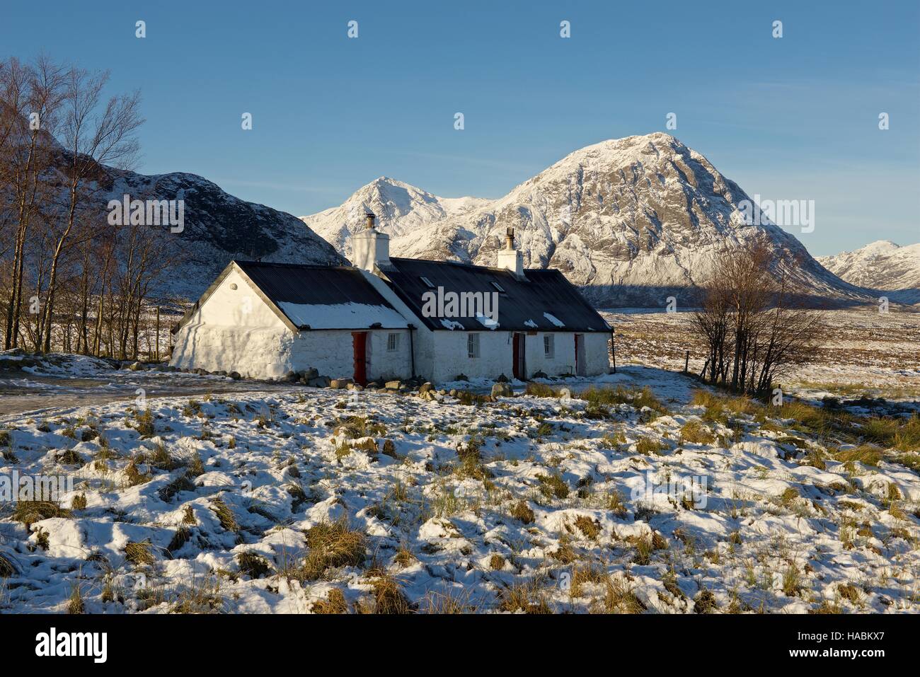 Black Rock Cottage with the peak of Stob Dearg in the distance taken in winter Stock Photo
