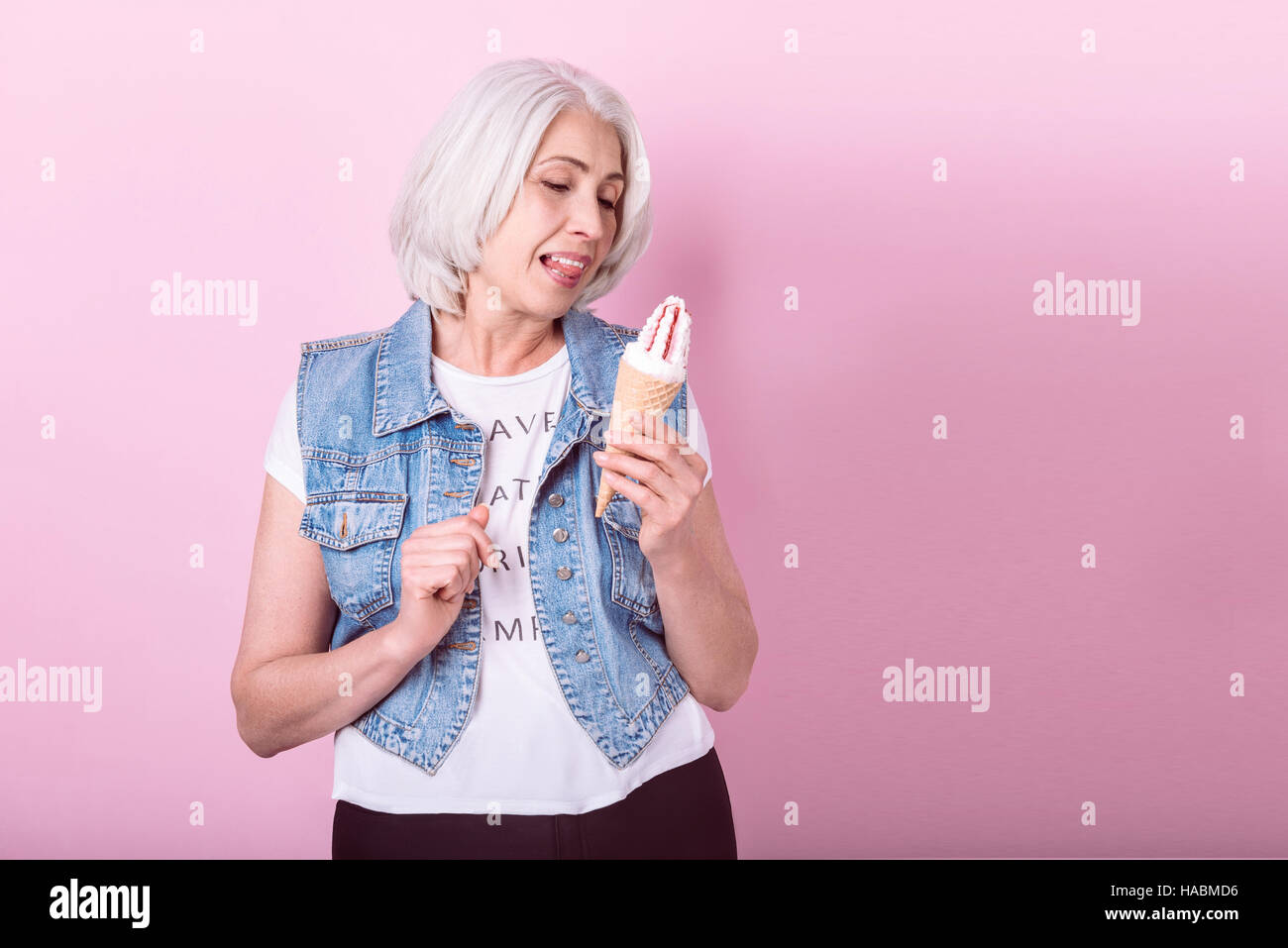 Emotional senior woman holding an icecream. Stock Photo