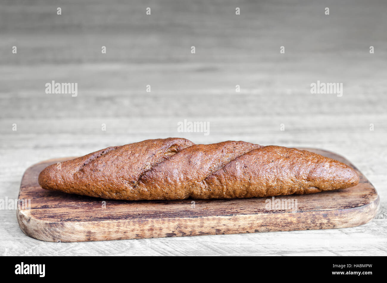 Bread is on grey wooden background Stock Photo - Alamy