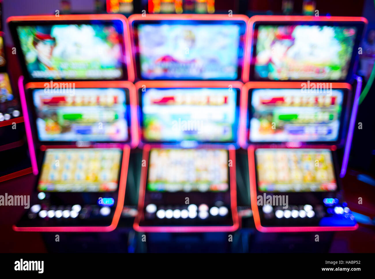 Blurry image of slots machines and other gambling equipment at a casino. Out of focus (bokeh) colourful and high contrast picture in a casino. Stock Photo