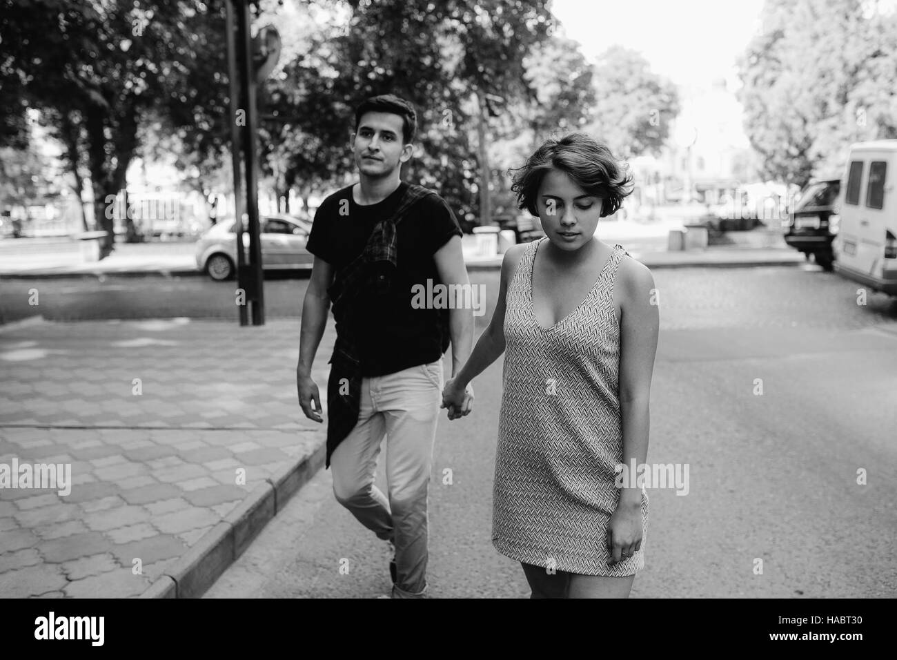 couple walking on the street holding hands Stock Photo - Alamy
