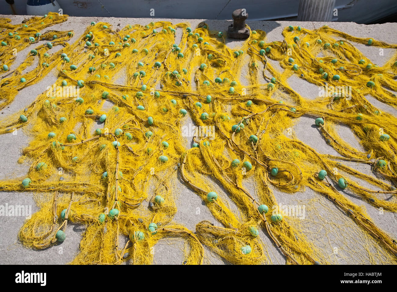 big yellow fishing net with floats closeup on pier Stock Photo Alamy