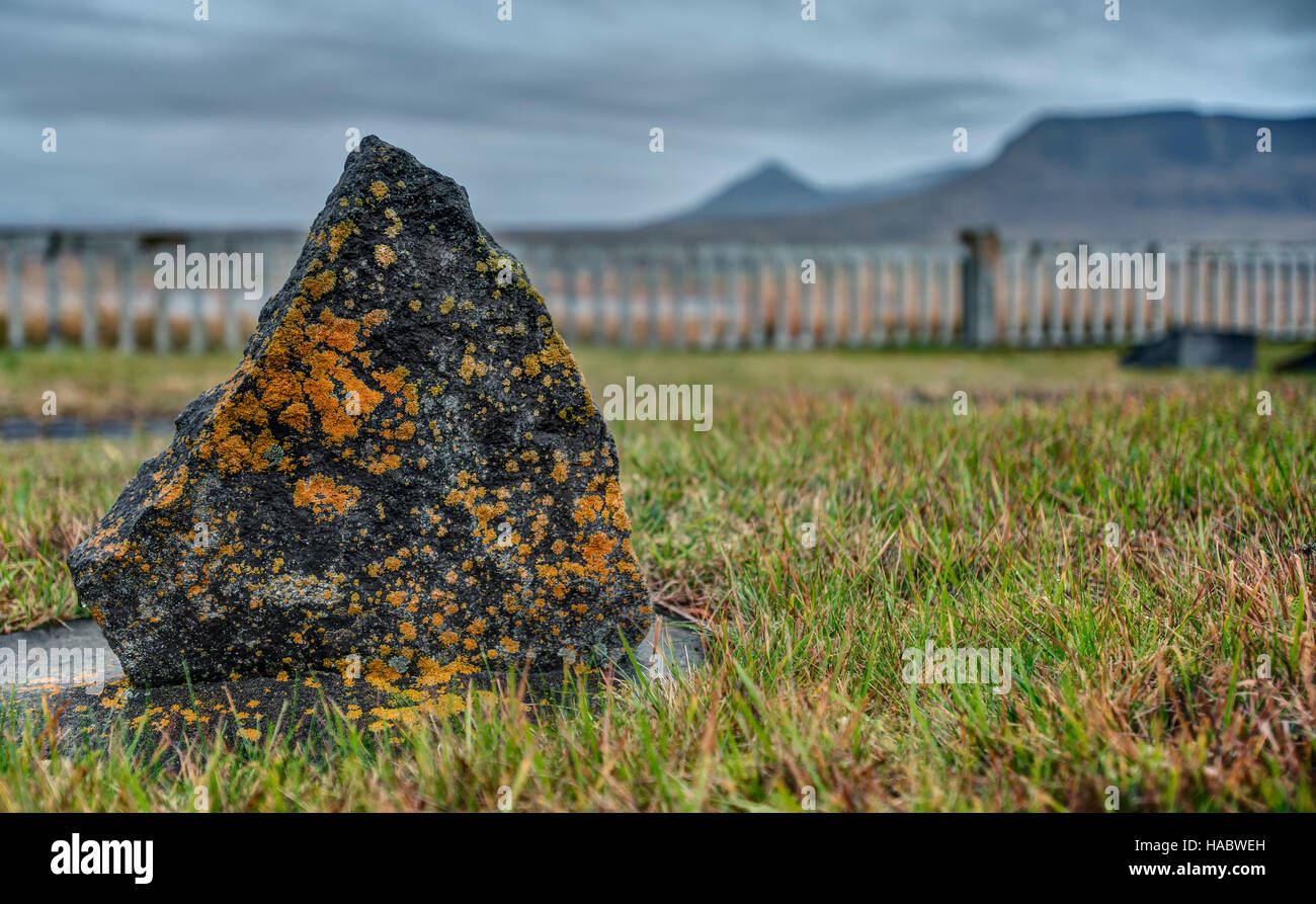 A Moss Covered Headstone marks a Grave atop an Iceland Hillside Stock Photo