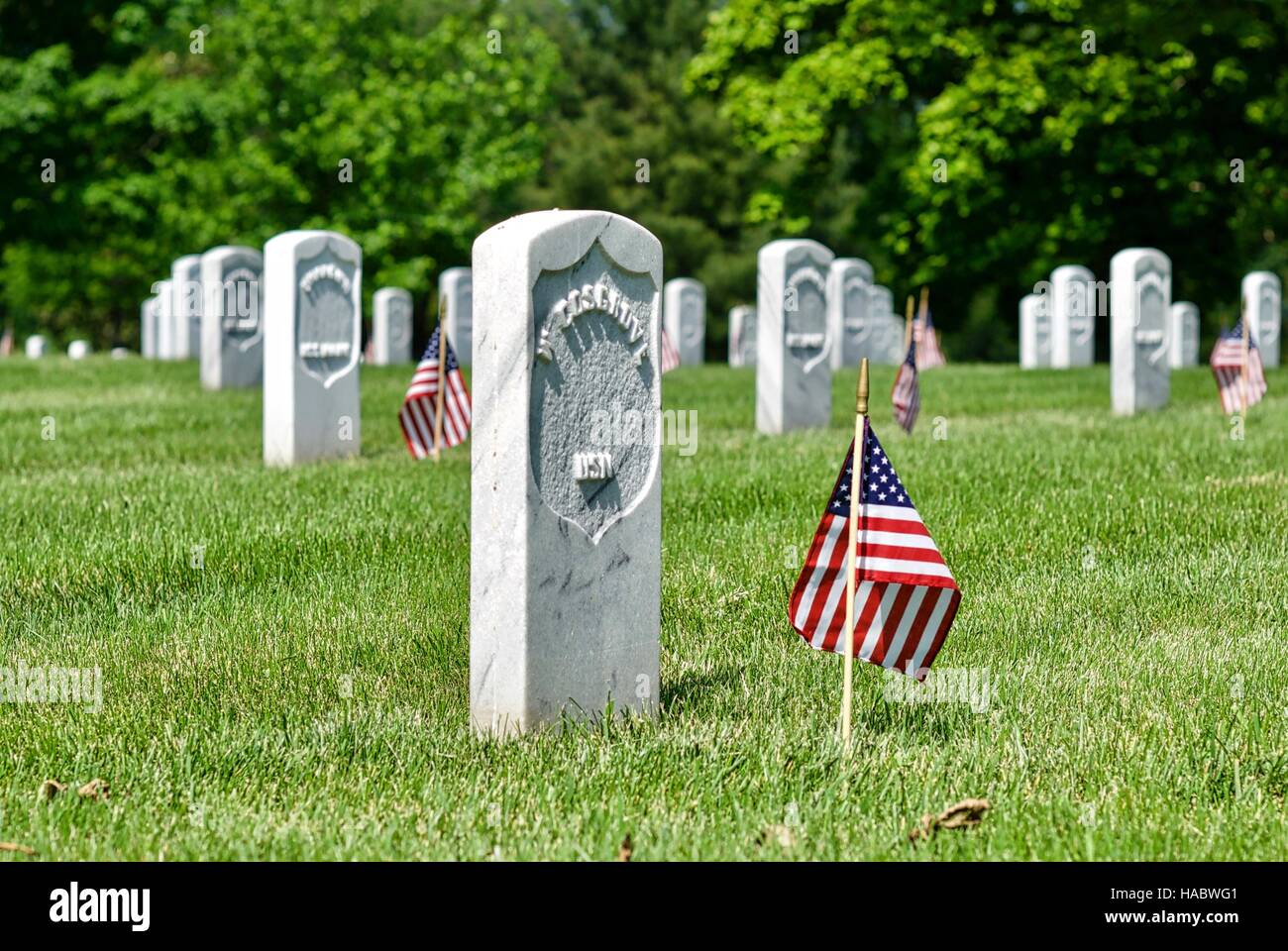 Gravestones with American flags at Arlington National Cemetery in Fort Myer, Arlington, Virginia, USA, on Memorial Day weekend. Stock Photo
