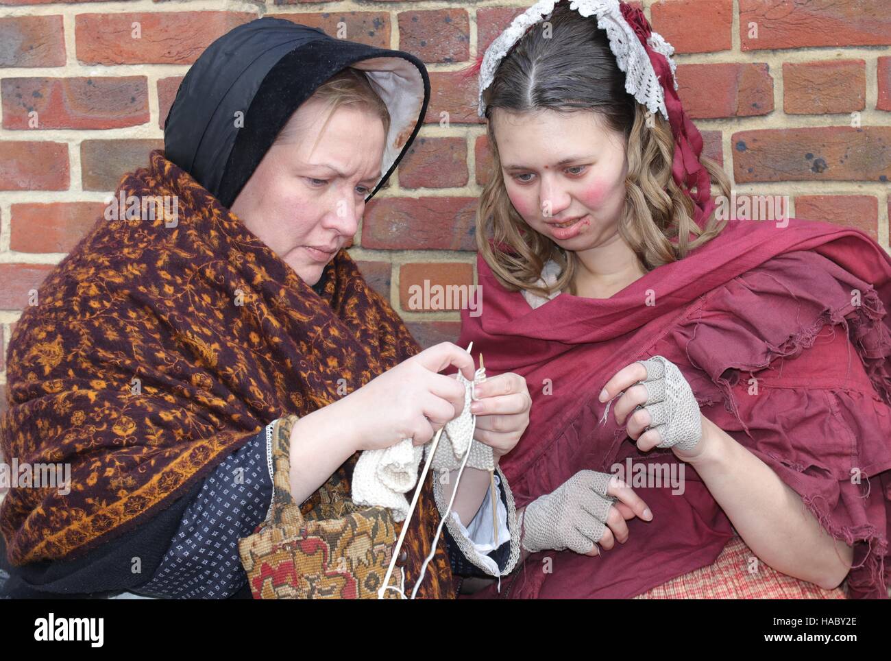 :Two unknown actors playing the part of  victorian women at the yearly Christmas victorian festival in portsmouth dockyard,england,26th november 2016 Stock Photo