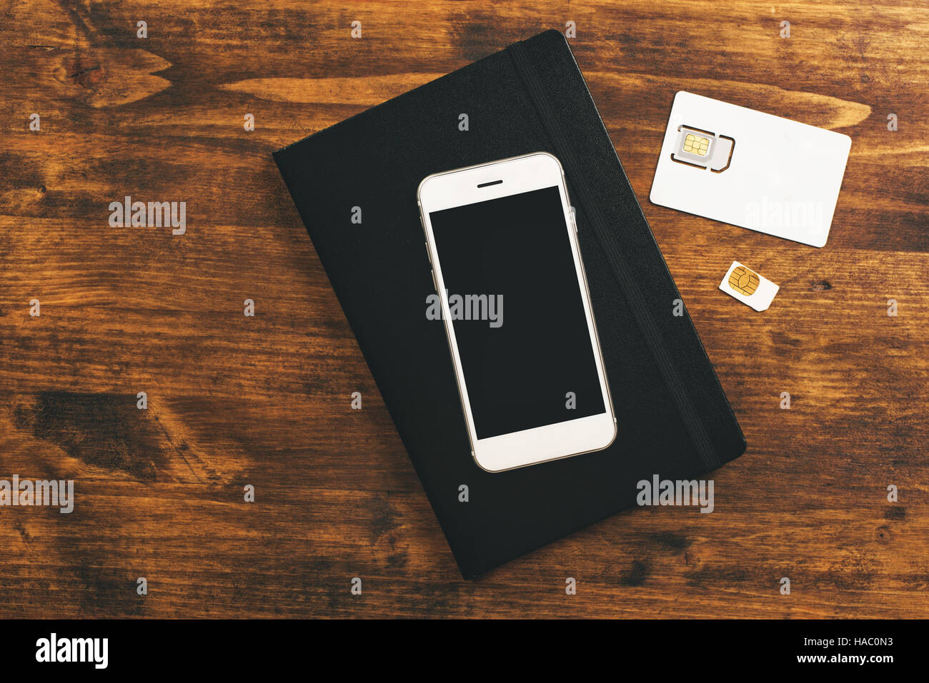 Switching SIM cards in smartphone, top view of mobile phone device on