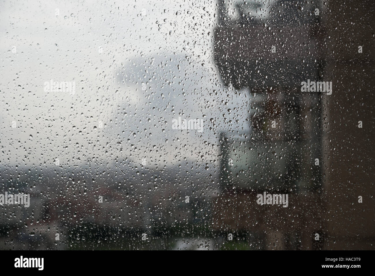 rain drops on glass with a blur apartment at background Stock Photo Alamy